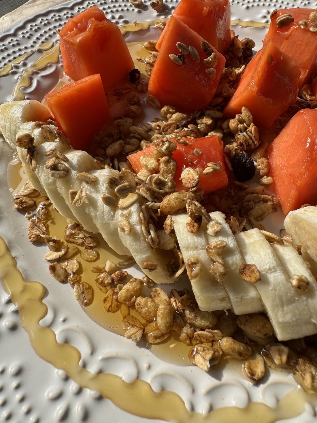 Prato de banana e mamão com granola e mel